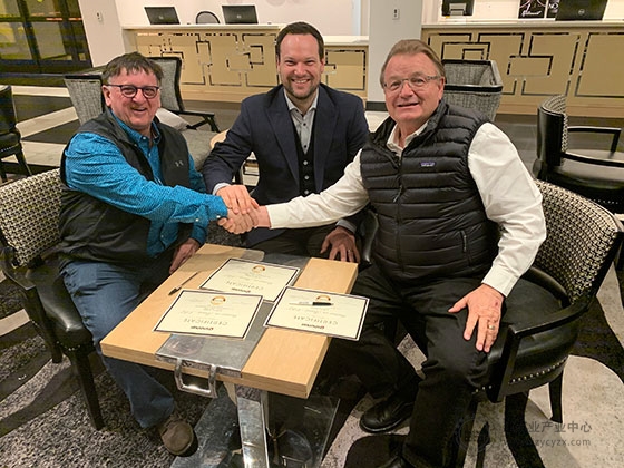 Alcide-Leblanc-(left)-and-Louis-Leblanc-(center)-of-Mortier-en-Trémie-ABL-signs-for-the-first-Snorkel-2100SJ-with-Snorkel-owner,-Don-Ahern-(right).jpg